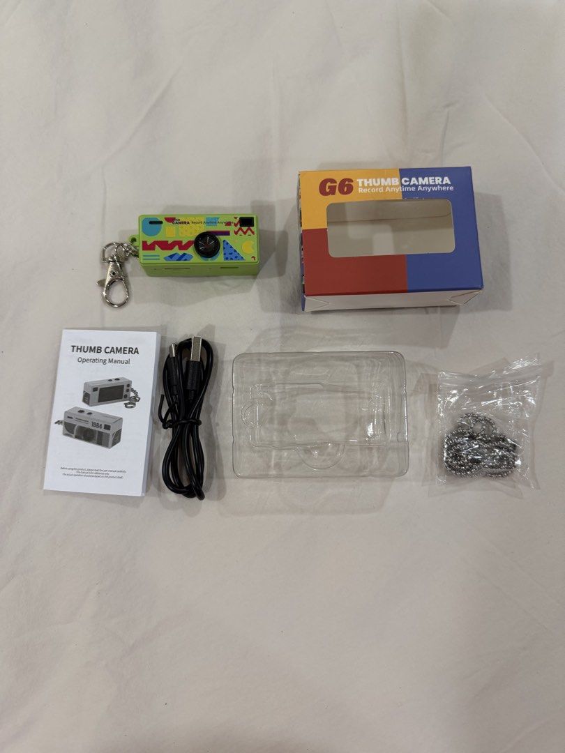 Rare color G6 Thumb Camera (Category: Cameras) located in Quezon City. Submitted by PrelovedTreasureees (Listing ID 1428328767, Image 2). Description: Purchased on Jan 2026 for 934 (995 original price). Only used a couple of times, mostly used as a bag charm. Inclusions and features: - 8 gb memory card included - All inclusions still complete (keychain, necklace attachment, charger, manual, box) - Can take photos, videos, and record audio - See 7
