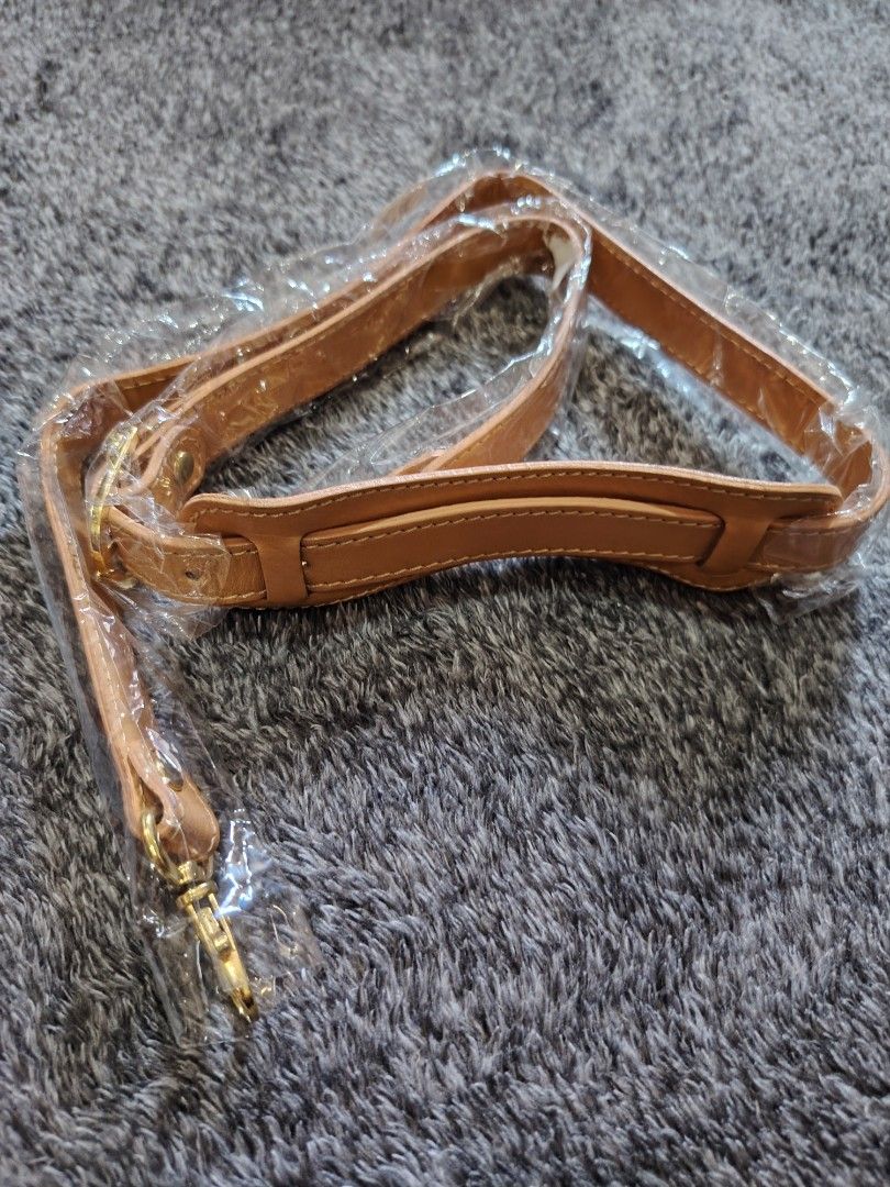 Jackie Bag Strap (Category: Luxury Bags & Wallets) located in Valenzuela. Submitted by anna.banana10 (Listing ID 1428313294, Image 1). Description: Replacement bag strap. It is light brown in color with gold-colored hardware. The strap has a padded shoulder section for comfort. The buckle is marked with the name "Jackie". The strap is still in its original packaging..