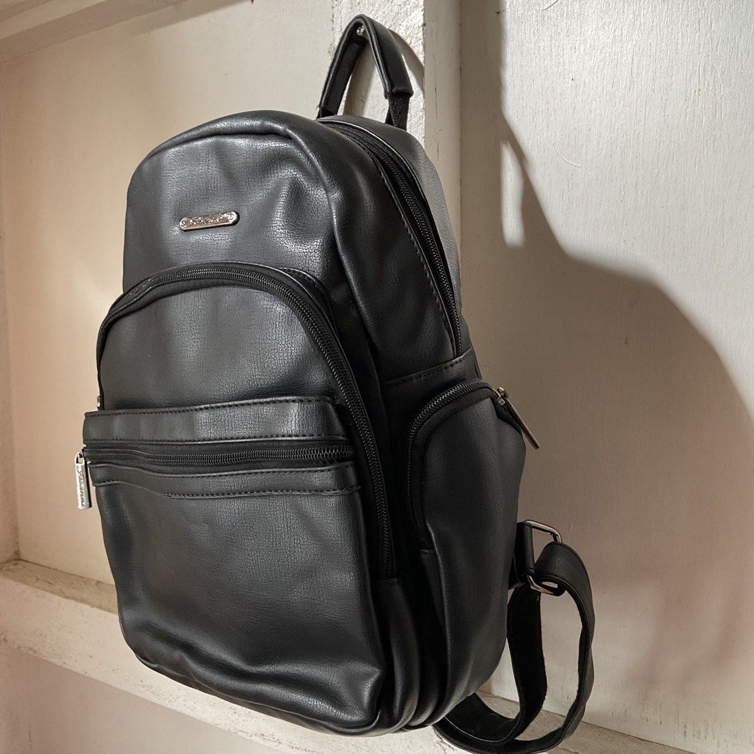 Black Backpack (lots of pockets, leather) (Category: Backpacks) located in Iloilo. Submitted by vanfits (Listing ID 1428324596, Image 1). Description: Features: - 6 external pockets (compartments) + 1 hidden pocket - Fits with 11-inches book as showned in the picture - Washable - Not easily get wet (inside) - Adjustable strap - LOTSSS of pockets - Well-cared 🎒.