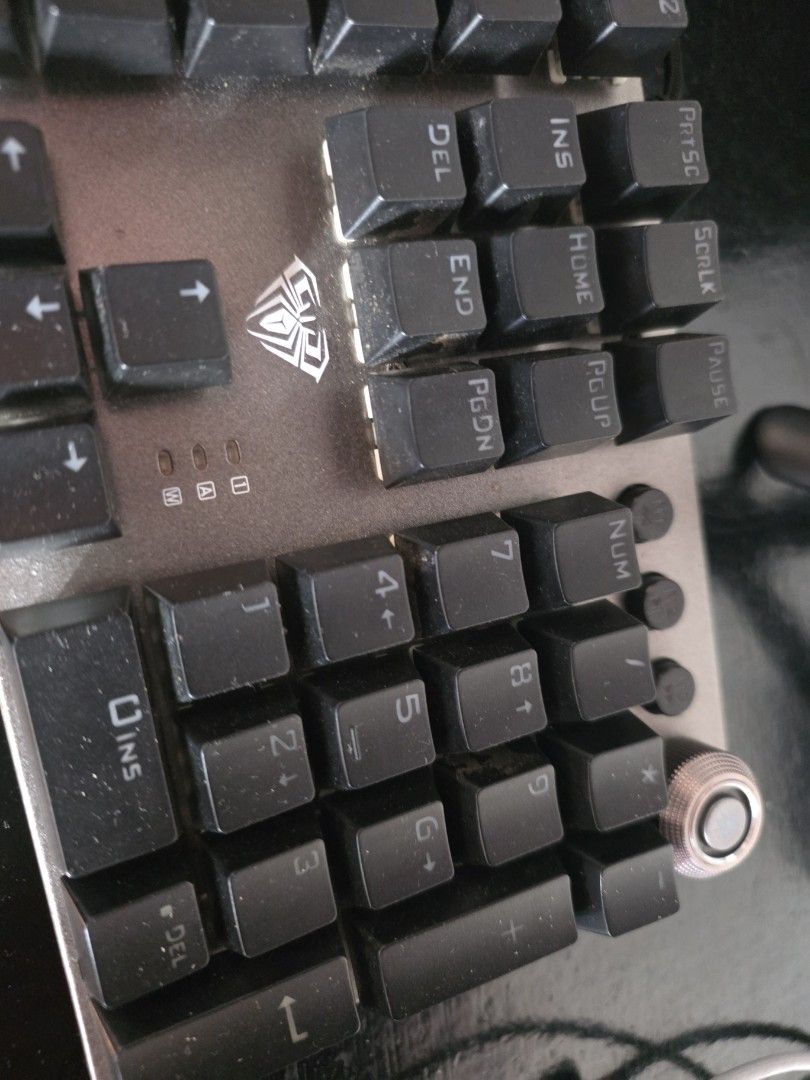 LOQ Mechanical Keyboard (Category: Computer Keyboard) located in Quezon City. Submitted by kentmaguid20 (Listing ID 1428322043, Image 2). Description: LOQ mechanical keyboard. Features a full-sized layout with a numeric keypad. The keyboard has black keycaps. The back of the keyboard shows the model number and other specifications. It is a wired keyboard. The keyboard has a silver frame..