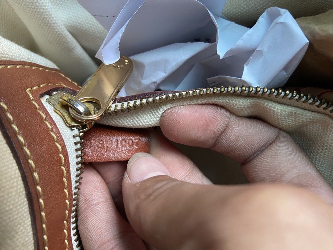 Louis Vuitton Cabas Rayures Tote Bag (Category: Luxury Bags & Wallets) located in Alcala. Submitted by abasolo_jv (Listing ID 1428390930, Image 3). Description: Authentic Louis Vuitton Cabas Rayures tote bag. Features the iconic LV monogram print with brown leather trim and accents. Includes a blue stripe design. The interior has a zip pocket and a canvas lining. The bag has a top zipper closure. Made in France. Serial number SP1007. Sign of use 