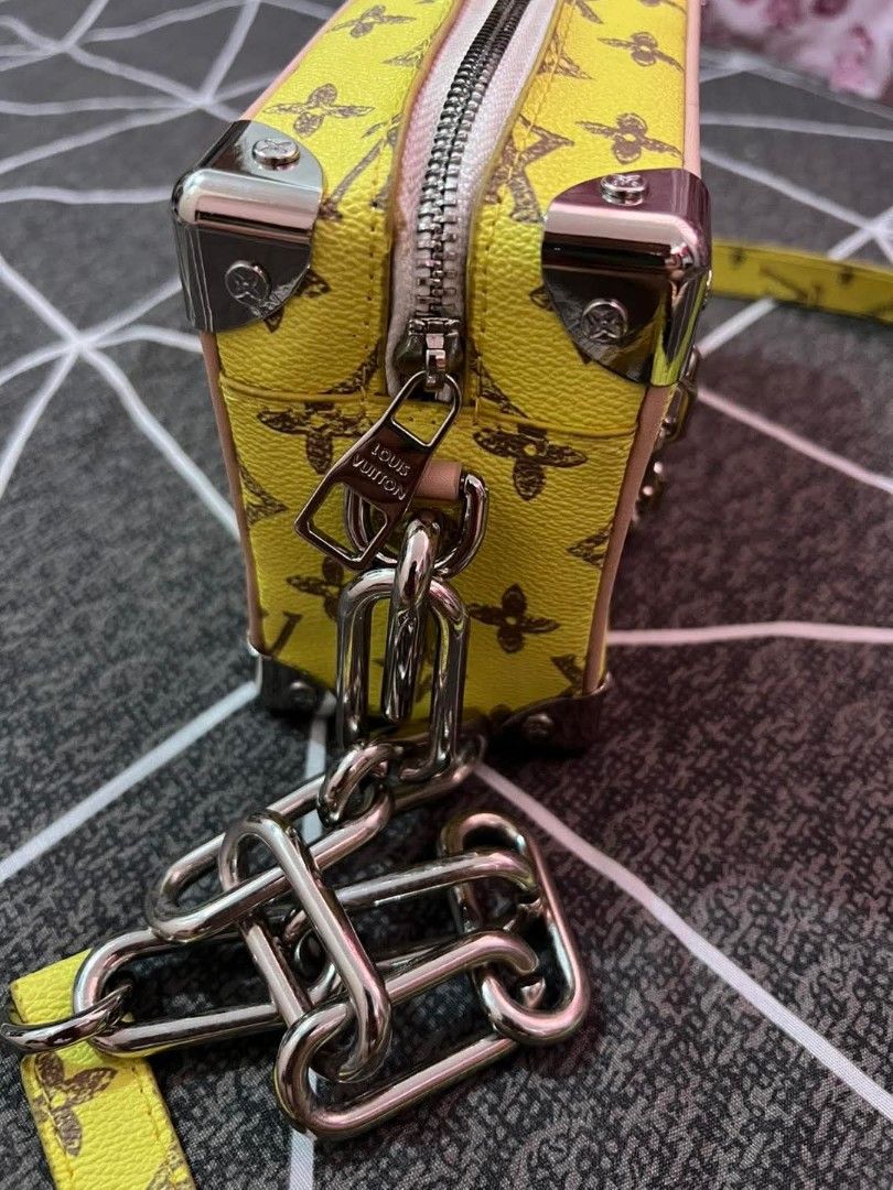 Louis Vuitton Yellow Crossbody Bag (Category: Luxury Bags & Wallets) located in Marikina City. Submitted by caiteeekat (Listing ID 1428262722, Image 2). Description: Louis Vuitton crossbody bag features a vibrant yellow exterior with the iconic LV monogram. It has a chain strap and a zip closure. The interior includes a small pocket with a Louis Vuitton label. The bag has silver-tone hardware and a detachable strap..