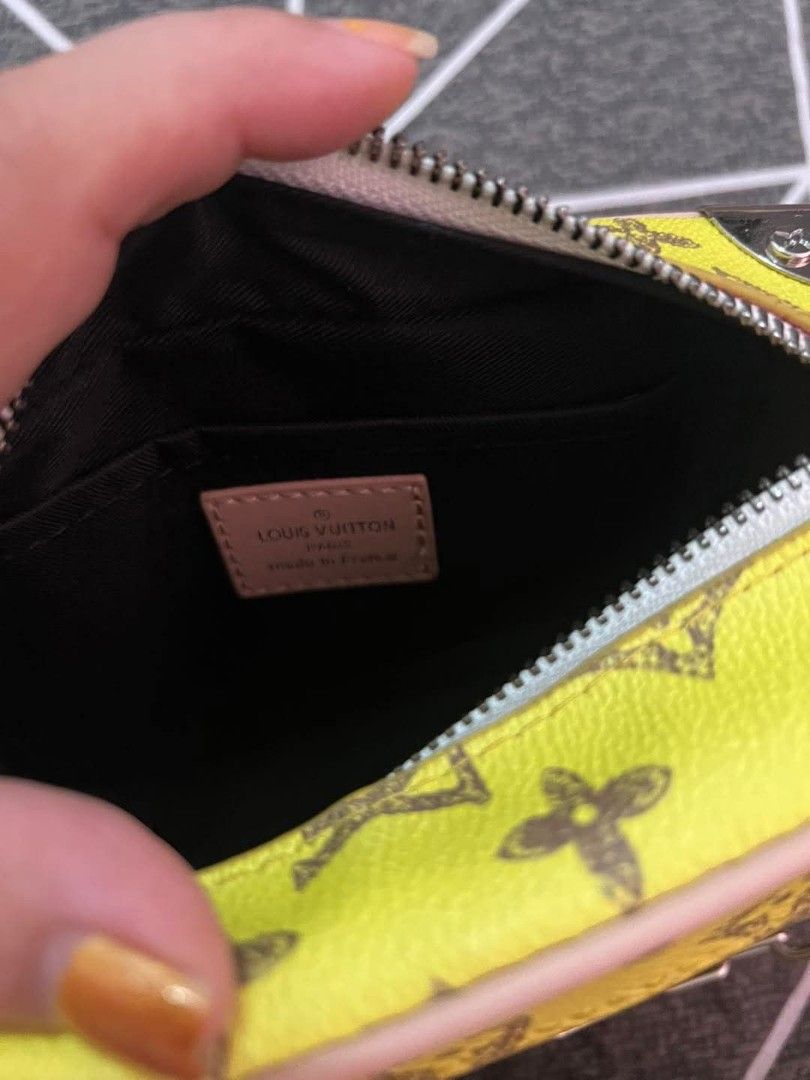 Louis Vuitton Yellow Crossbody Bag (Category: Luxury Bags & Wallets) located in Marikina City. Submitted by caiteeekat (Listing ID 1428262722, Image 3). Description: Louis Vuitton crossbody bag features a vibrant yellow exterior with the iconic LV monogram. It has a chain strap and a zip closure. The interior includes a small pocket with a Louis Vuitton label. The bag has silver-tone hardware and a detachable strap..