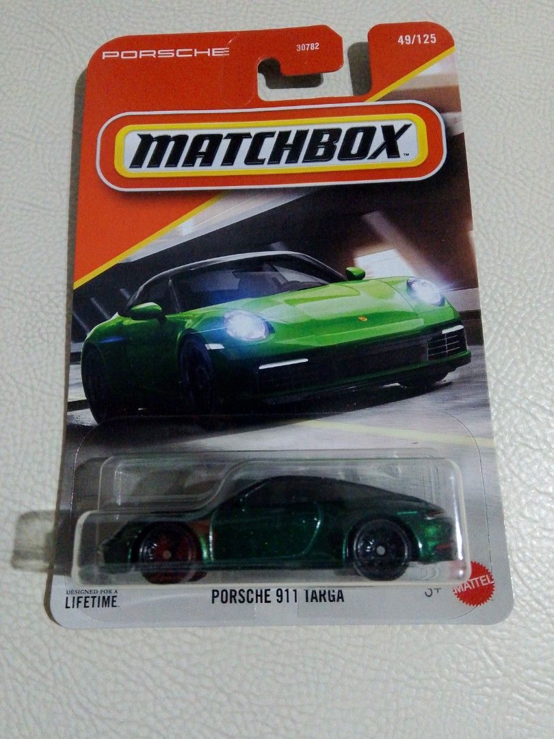 Matchbox Porsche 911 Targa (Category: Vehicle & Diecast Models) located in Paranaque City. Submitted by g-books-n-toys (Listing ID 1428401290, Image 1). Description: Matchbox Porsche 911 Targa diecast car. Features a green body with black wheels. The car is part of the 49/125 series. The packaging includes the Porsche logo and the Matchbox branding. The car is in its original packaging..