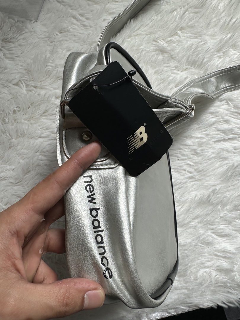 New Balance Silver Crossbody Bag (Category: Sling Bags) located in Manila. Submitted by johnmoral58013 (Listing ID 1428300504, Image 3). Description: Level up your street style with this head-turning Silver New Balance Crossbody Bag. Perfectly blending vintage athletic aesthetics with a modern metallic pop, this is the “it” accessory your wardrobe has been waiting for. Why You’ll Love It: • Standout Style: Eye-catching silver finish with a cool p