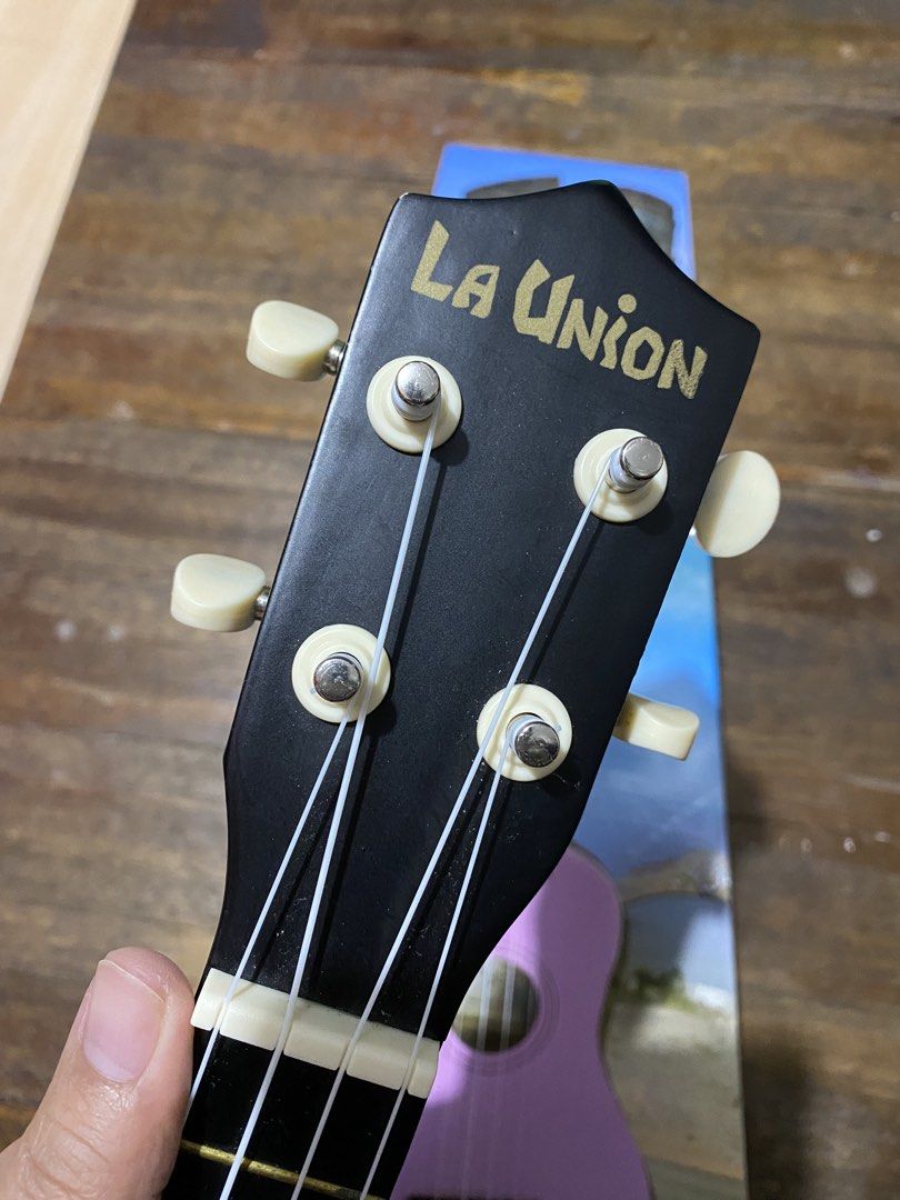 RJ La Union Ukulele Soprano with Bag (Category: Musical Instruments) located in Makati City. Submitted by lasthing.22 (Listing ID 1428423288, Image 3). Description: La Union ukulele comes with a black finish and a matching carrying case. The ukulele features a black headstock with the brand name in gold lettering. The body has a round sound hole and white accents. The included case has a zipper closure and the RV logo. RFS: Declutter With origina