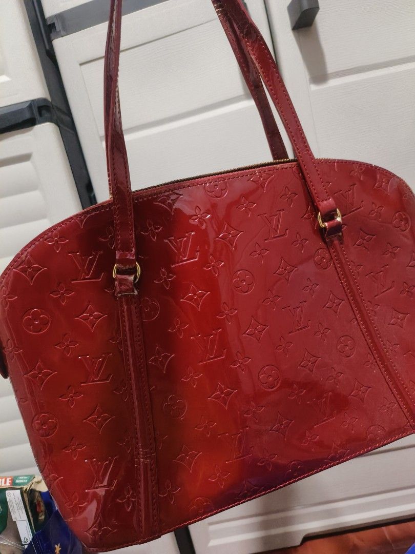 SALE LV Vernis Red CODED BAG (Category: Luxury Bags & Wallets) located in Manila. Submitted by teacherkei (Listing ID 1428404694, Image 2). Description: Features a zip closure, interior pockets, and gold-tone hardware. The interior is lined with red fabric. Includes a serial number SP0090. Made in France. The bag has some signs of wear on the straps..