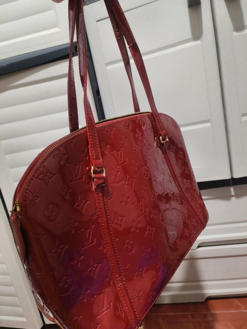 SALE LV Vernis Red CODED BAG (Category: Luxury Bags & Wallets) located in Manila. Submitted by teacherkei (Listing ID 1428404694, Image 3). Description: Features a zip closure, interior pockets, and gold-tone hardware. The interior is lined with red fabric. Includes a serial number SP0090. Made in France. The bag has some signs of wear on the straps..