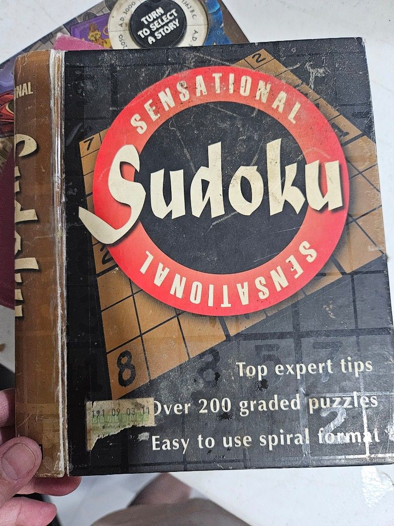 Sensational Sudoku Puzzle Book (Category: Board Games & Puzzles) located in Manila. Submitted by just_about_anything (Listing ID 1428327462, Image 1). Description: Sensational Sudoku puzzle book offers over 200 graded puzzles with expert tips. It features easy-to-use spiral format. The book includes puzzles of varying difficulty levels, from easy to hard. Some puzzles have been solved, as seen in the images. The book is a great way to challenge y