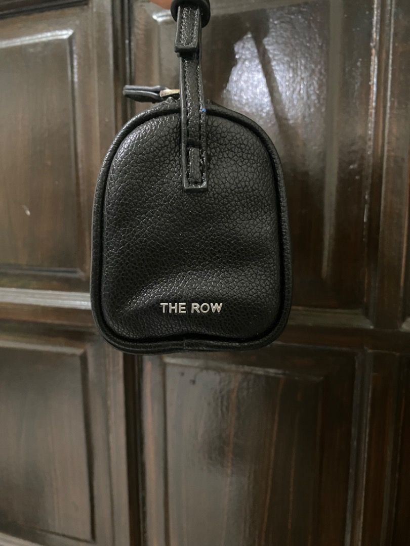 The Row 90’s Mini Bag (Category: Luxury Bags & Wallets) located in Manila. Submitted by haveago0dthrift (Listing ID 1428383863, Image 3). Description: -Black mini bag from The Row. -The bag has a cylindrical shape. -The Row logo is visible on the side. .