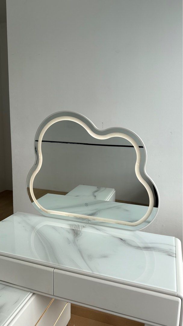 Vanity table / Dressing table (Category: Tables & Sets) located in Petaling Jaya. Submitted by fawahinshirah (Listing ID 1428353524, Image 3). Description: Bought for RM 1.5k selling at RM600 SELF PICKUP AT BANDAR SRI DAMANSARA LALAMOVE IS AT ADDITIONAL COST - Cloud-shaped LED mirror - White marble-look vanity table - Two drawers for storage - Matching table with 6 drawer storage - Touch sensor for LED lights (3 changeble colours) LED lights also