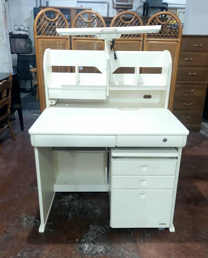 White Study Desk with Hutch and Drawers (Category: Tables & Sets) located in Manila. Submitted by luckyfalcon.510cbb (Listing ID 1428315592, Image 2). Description: White study desk features a hutch with shelves and a built-in light. It includes a keyboard tray and a set of drawers for storage. The desk's dimensions are approximately 30 inches in height, 38 inches in length, and 30 inches in width. It has a clean, minimalist design suitable for an
