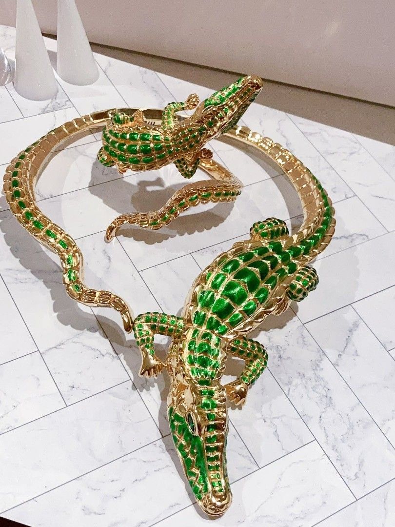 18k Gold Alligator Jewelry Set (Category: Earrings) located in Manila. Submitted by primejewelry (Listing ID 1428476539, Image 1). Description: Elegant gold-toned jewelry set featuring alligator designs. Includes a necklace, bracelet, and earrings. The necklace has a large alligator pendant with green enamel detailing. The bracelet also features an alligator design. The earrings have a smaller alligator design. A unique and eye-catching set perfe