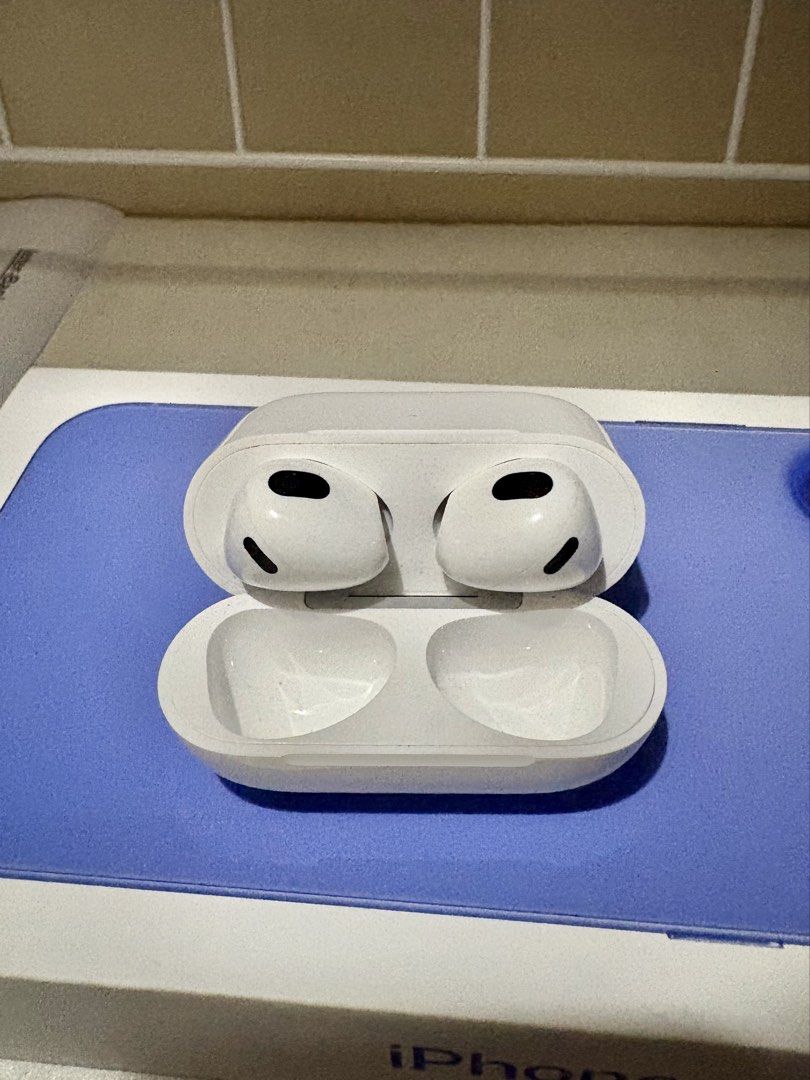 Apple AirPods 3rd Generation (Category: Earphones) located in Manila. Submitted by leinad22 (Listing ID 1428430863, Image 2). Description: Apple AirPods 3rd Generation with charging case. The earphones and case are white. The charging case has a lightning port. The AirPods are in the open case, showing the earbud design. The case has a small pairing button on the back. The model number is visible on the case..