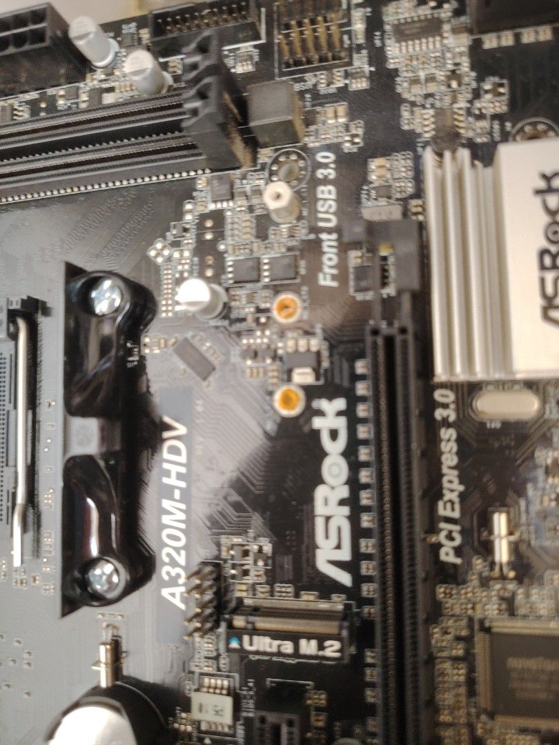 ASRock A320M-HDV Motherboard (Category: Computer Parts) located in Marikina City. Submitted by lumaynojan17296 (Listing ID 1428495633, Image 2). Description: ASRock A320M-HDV motherboard. Features include Ultra M.2 slot, PCI Express 3.0, and front USB 3.0 ports. Compatible with AMD processors. The board has various ports for connectivity. The model name is clearly visible on the board..