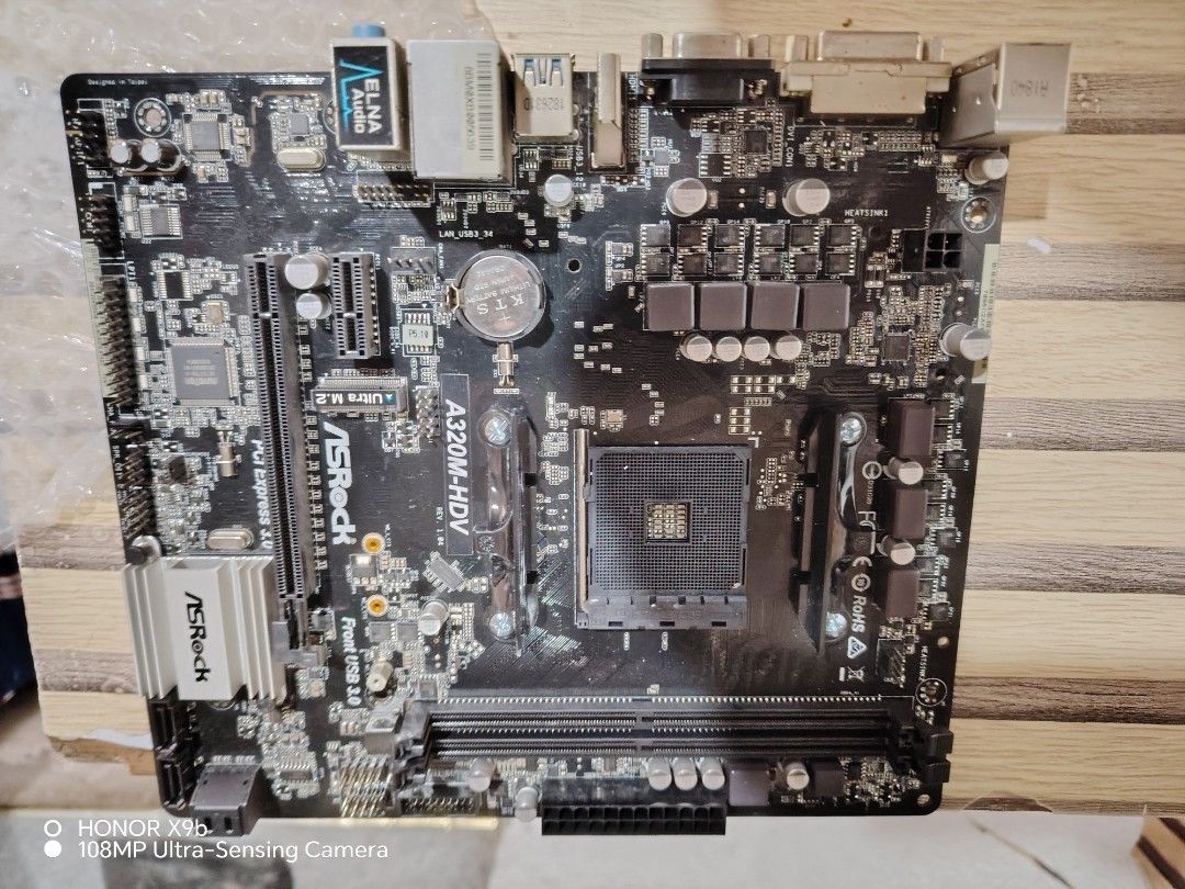 ASRock A320M-HDV Motherboard (Category: Computer Parts) located in Marikina City. Submitted by lumaynojan17296 (Listing ID 1428495633, Image 1). Description: ASRock A320M-HDV motherboard. Features include Ultra M.2 slot, PCI Express 3.0, and front USB 3.0 ports. Compatible with AMD processors. The board has various ports for connectivity. The model name is clearly visible on the board..