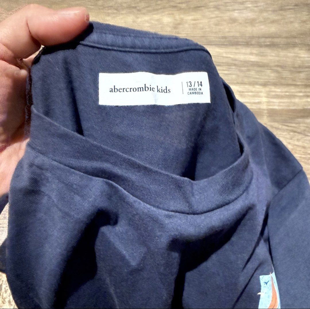 Authentic Abercrombie & Fitch blue shirt (Category: Babies & Kids Fashion) located in Quezon City. Submitted by iamannp (Listing ID 1428471978, Image 2). Description: Authentic Abercrombie blue tshirt Size 13/14 Theres like an oil stain but not noticeable since dark color Outgrown by my son.