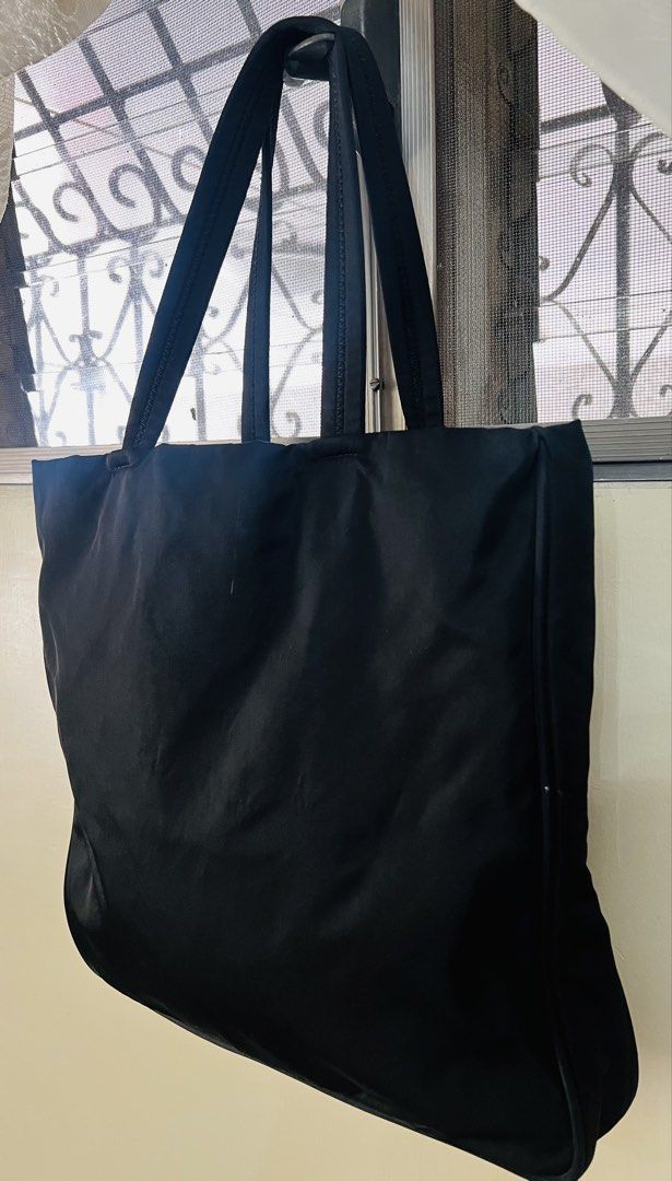 Authentic Prada Nylon Shoulder/Tote Bag (Category: Luxury Bags & Wallets) located in Antipolo. Submitted by yellow_15 (Listing ID 1428459689, Image 2). Description: Still in very good used condition With working zip pocket inside No major flaw/damages, just normal signs of usage 3 compartment, very roomy Velcro closure - middle compartment All handles are intact Corners are still good (no holes) Dimension - Approx (L) 13” x 13.5” (W) .