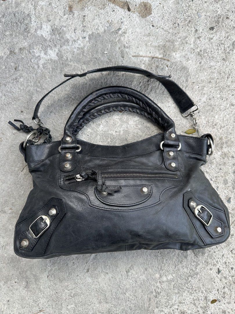 Balenciaga Classic City Handbag (Category: Luxury Bags & Wallets) located in Santa Rosa. Submitted by archivedrip (Listing ID 1428590039, Image 1). Description: Black Balenciaga Classic City handbag. Features a braided top handle and a detachable shoulder strap. Includes a front zip pocket and silver-tone hardware. The interior has a zip pocket. Made in Italy. The zipper has a "LAMP" marking..