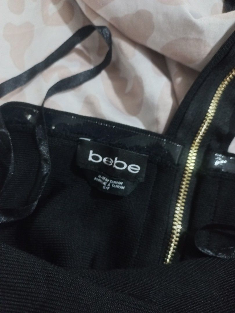 Bebe Black Mini Dress (Category: Dresses) located in Manila. Submitted by maryjoyenc89891 (Listing ID 1428488285, Image 2). Description: Black mini dress from Bebe. Features a gold zipper detail and a strapless design. The dress is made in Taiwan. The dress has a fitted silhouette..