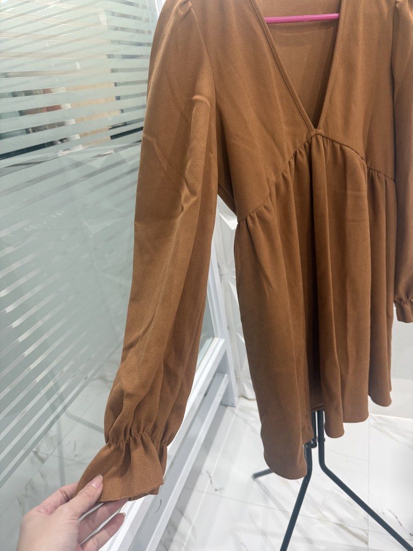 Brown V-Neck Long Sleeve Dress (Category: Dresses) located in Arayat. Submitted by ico_riv (Listing ID 1428471239, Image 2). Description: Dress features a flattering V-neckline and long sleeves. It has a gathered detail under the bust, creating a flowy silhouette. The sleeves have a slight puff at the shoulders and are finished with ruffled cuffs. Fits medium to large..
