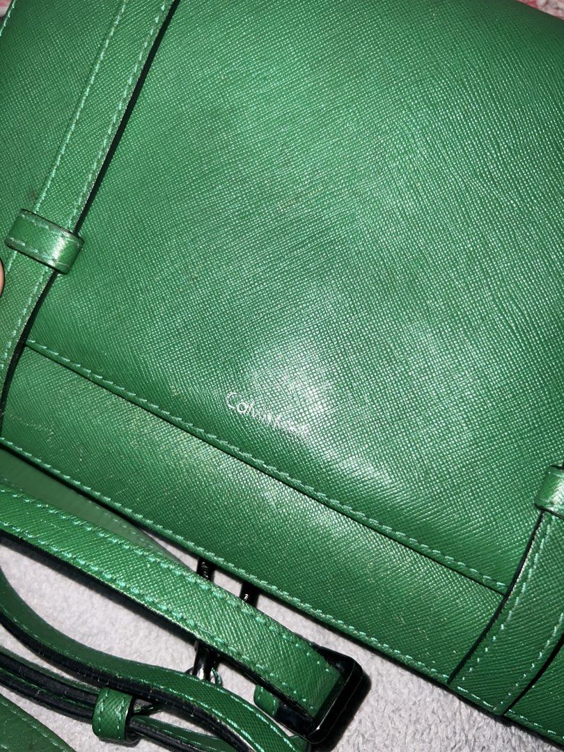 Calvin Klein Green Crossbody Bag (Category: Cross-body Bags) located in Bulacan. Submitted by thriftstationplus (Listing ID 1428560855, Image 2). Description: Made in China ✅ Overall Condition - 8/10 💯 % Genuine Leathher 🏆Condition of: 🐮Leather - 7.8/10 🪨 Edge Paint - 7/10 🛠️Hardwares - 8.5/10 ➰Strap/Sling - 7.4/10 📉Lining/Edges - 8/10 🧐Interior - 8/10 🧬Measurements: * Height: * Length: * Width: * Strap/Sling: : Can Be Handheld or Crossbo
