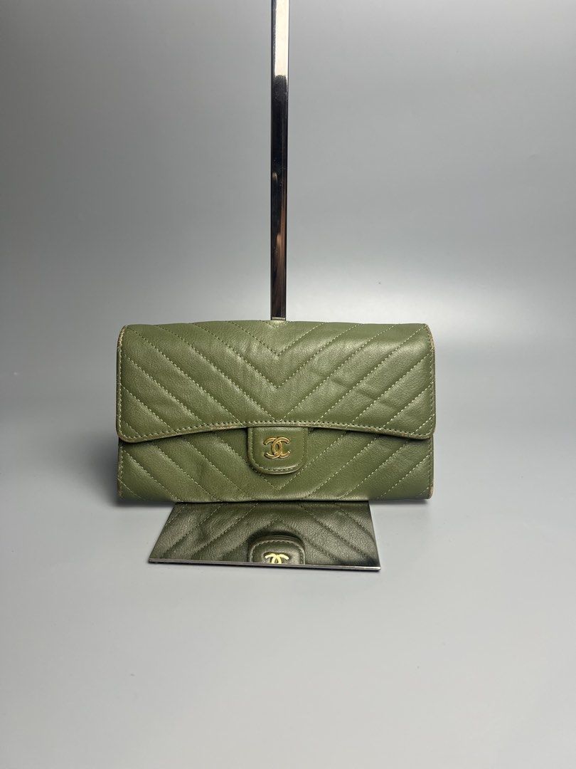 Chanel Chevron Wallet Olive Green (Category: Luxury Bags & Wallets) located in Manila. Submitted by reclaim.13 (Listing ID 1428492503, Image 1). Description: Chanel wallet in olive green. Features a chevron design and the iconic CC logo. The interior includes multiple card slots and a zippered compartment. Made in Italy. Serial number 23019973..