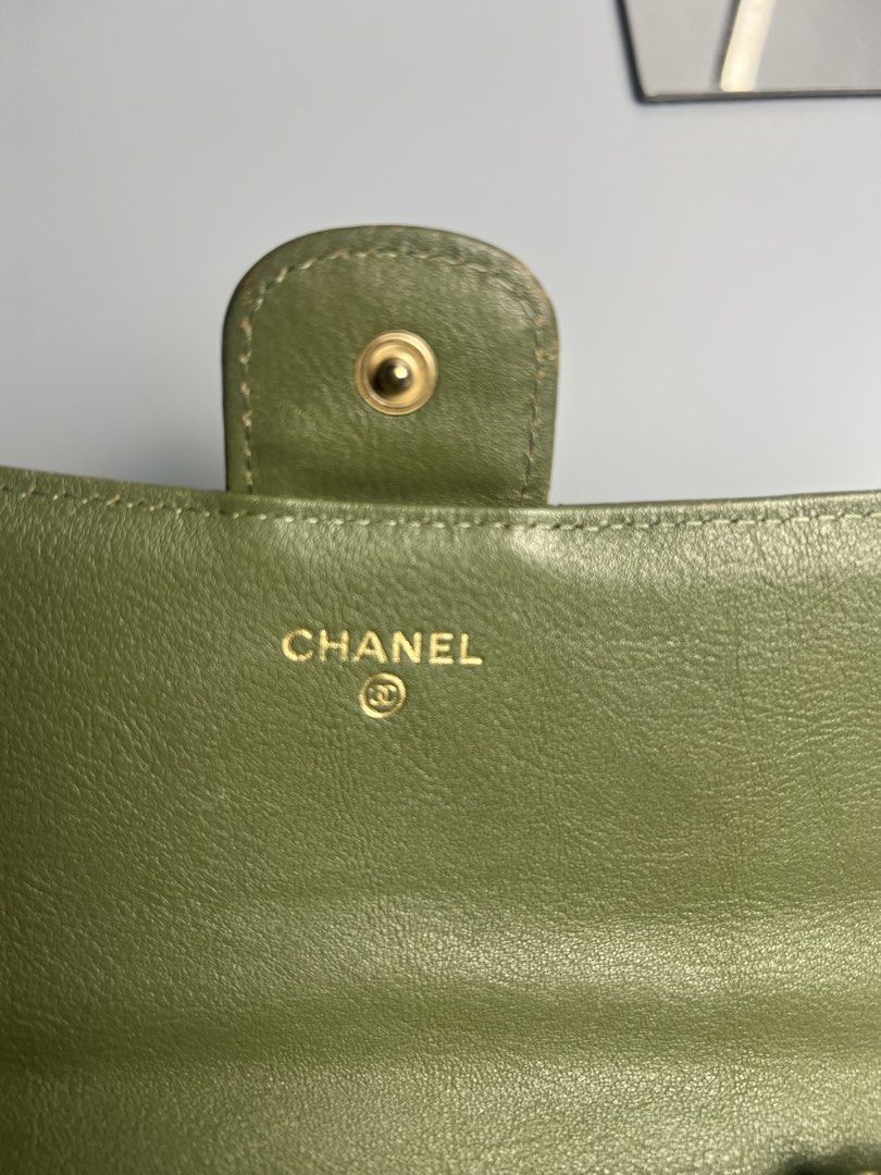 Chanel Chevron Wallet Olive Green (Category: Luxury Bags & Wallets) located in Manila. Submitted by reclaim.13 (Listing ID 1428492503, Image 2). Description: Chanel wallet in olive green. Features a chevron design and the iconic CC logo. The interior includes multiple card slots and a zippered compartment. Made in Italy. Serial number 23019973..