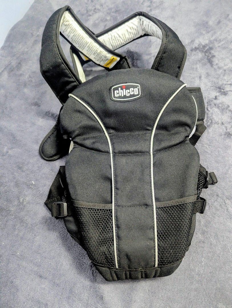 Chicco Baby Carrier (Category: Carriers & Slings) located in Makati City. Submitted by decluterave_2026 (Listing ID 1428565511, Image 1). Description: Black Chicco baby carrier. Features adjustable straps and a mesh pocket. The carrier has a white trim and the Chicco logo is visible on the front. The carrier has a sturdy design..