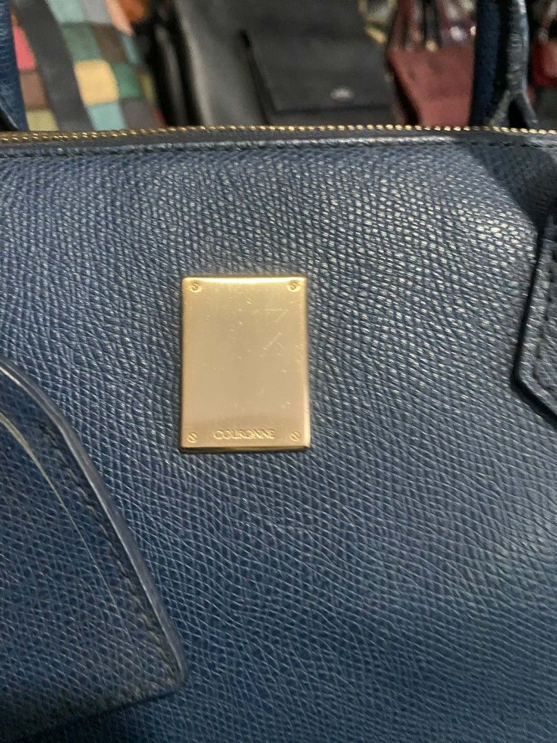 Couronne Blue Leather Tote Bag (Category: Tote Bags) located in Bayombong. Submitted by kweeeen (Listing ID 1428542994, Image 2). Description: Blue leather tote bag by Cole Haan. It features a rectangular gold-colored plate on the front and a matching tag. The bag has two handles and a zipper closure. The bag is a medium size, suitable for everyday use..