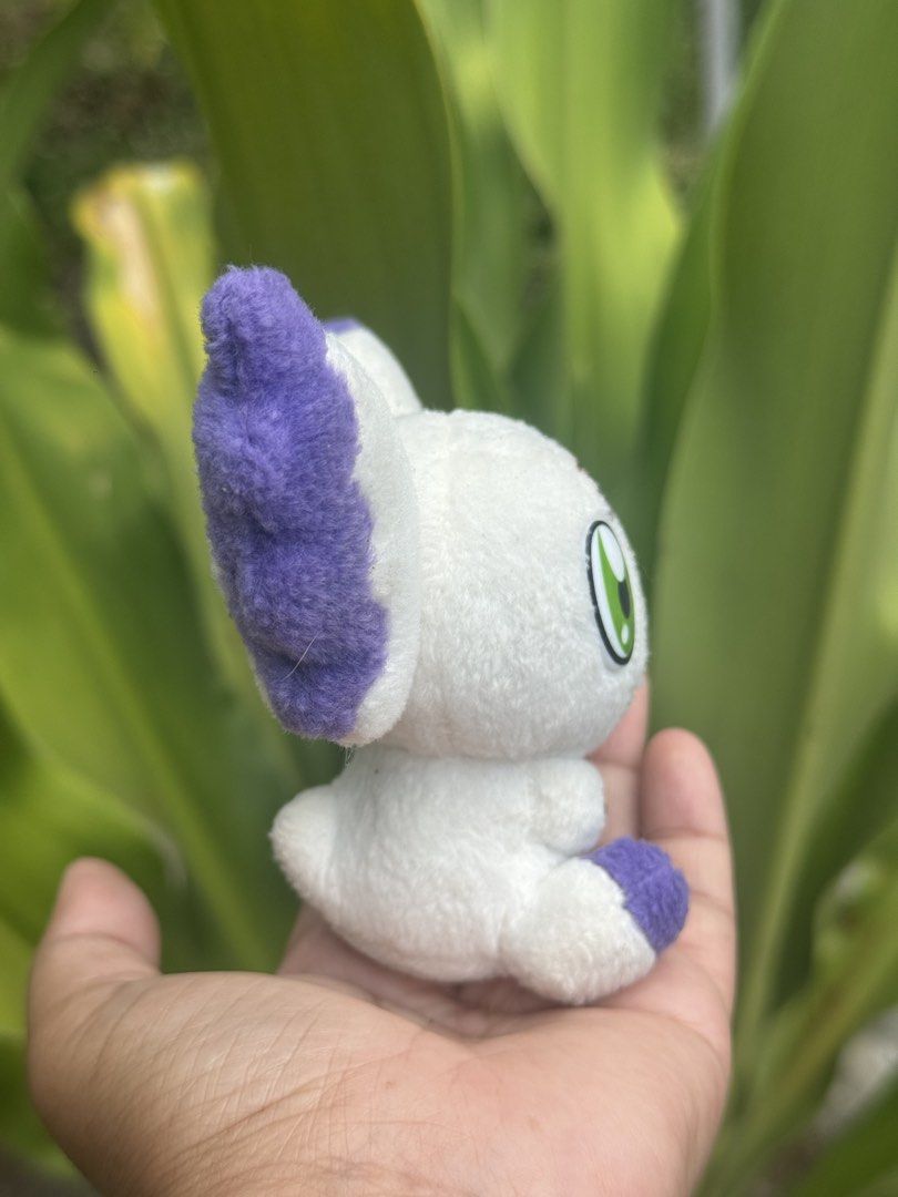 Digimon Patamon Plush Toy (Category: Plushies & Soft Toys) located in Antipolo. Submitted by bhabiegraciefashionlab (Listing ID 1428490706, Image 2). Description: Adorable Patamon plush toy. Features white body with purple accents on the ears and feet. It has green eyes and a red triangle on its forehead. The tag indicates it was made by Bandai in 2001. A cute collectible for Digimon fans..