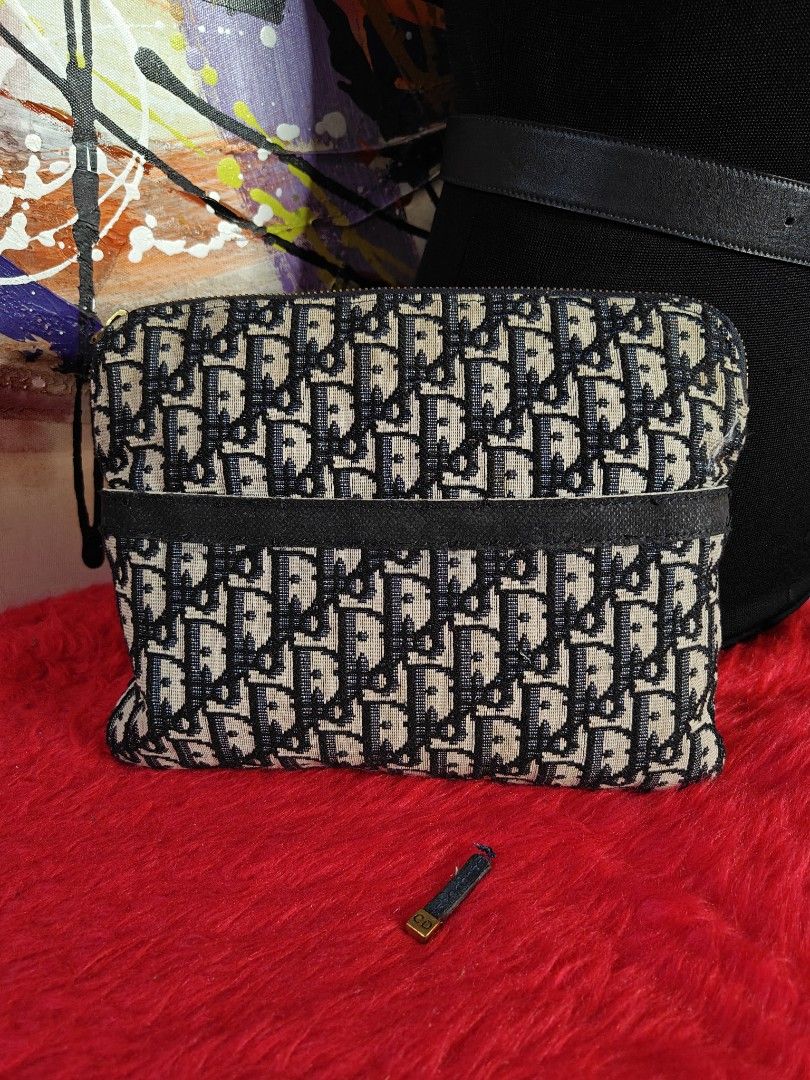 Dior Oblique Clutch (Category: Luxury Bags & Wallets) located in Las Pinas. Submitted by liezel49 (Listing ID 1428433649, Image 1). Description: Authentic Dior Oblique clutch. Features the iconic Dior Oblique pattern. The clutch has a zip closure with a gold-tone zipper. The clutch has a wrist strap. Approximate dimensions are 25cm in length..