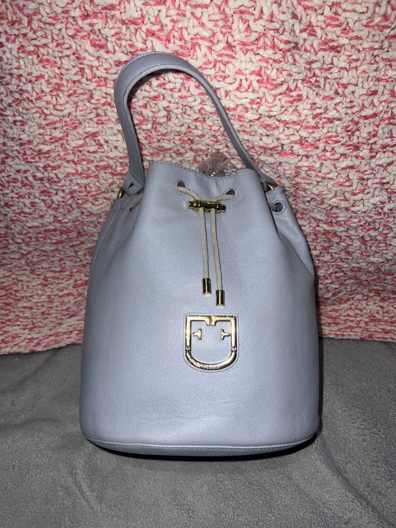 Furla Bucket Bag with Pouch and Strap (Category: Luxury Bags & Wallets) located in Bulacan. Submitted by thriftstationplus (Listing ID 1428563063, Image 2). Description: Made in Italy ✅ Overall Condition - 9/10 💯 % Genuine Leathher 🏆Condition of: 🐮Leather - 9/10 🪨 Edge Paint - 9/10 🛠️Hardwares -9/10 ➰Strap/Sling - Replaced Sling 8.5/10 📉Lining/Edges - 9/10 🧐Interior - 9.8/10 🔗 Puller - 8/10 🧬Measurements: * Height: 10in * Length: 8in * W