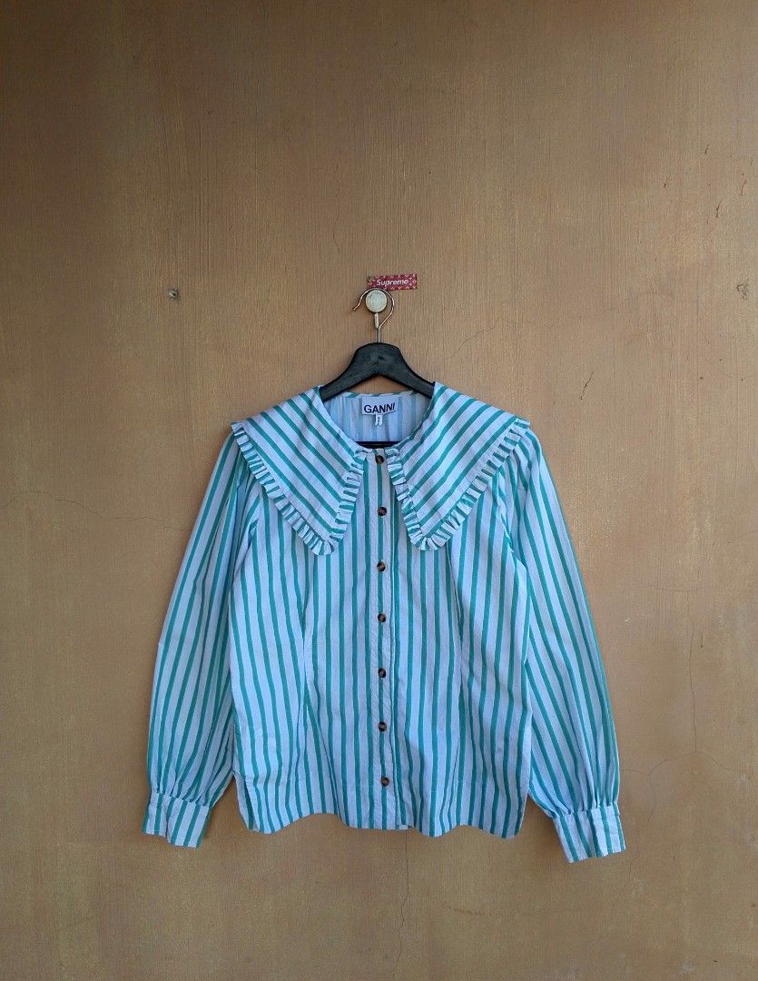 Ganni Ruffled Collar Stripe Poplin Blouse (Category: Luxury Apparel) located in Lipa City. Submitted by MEECHYTWO2TWO (Listing ID 1428478514, Image 1). Description: - Ganni Ruffled Collar Poplin Blouse - Size: 34 / Best fit to M-L - Width: 19 / Length: 24 - Location: Lipa City, Batangas - Excellent condition - Color rate: 10/10 - Additional sf +75 - Mop: GCASH/NO COD - Payment first tomorrow will be shipped - 09919484823.