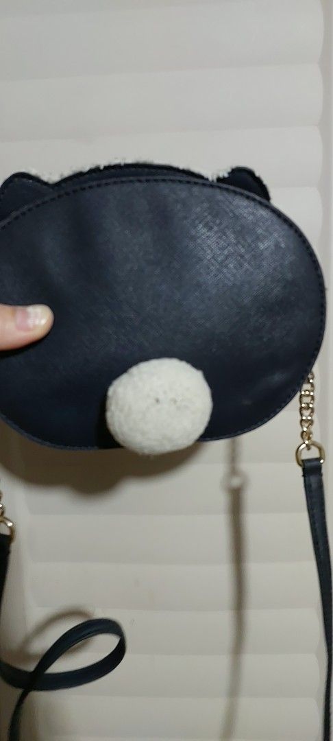 Kate Spade Polar Bear Crossbody Bag (Category: Cross-body Bags) located in Echague. Submitted by grateful27 (Listing ID 1428546472, Image 2). Description: Adorable Kate Spade crossbody bag featuring a polar bear design. It has a navy blue body with a white fluffy exterior and a gold chain strap. The bag has a zipper closure and a small white pom-pom detail on the back. The interior is lined with a navy blue fabric with the Kate Spade New York log