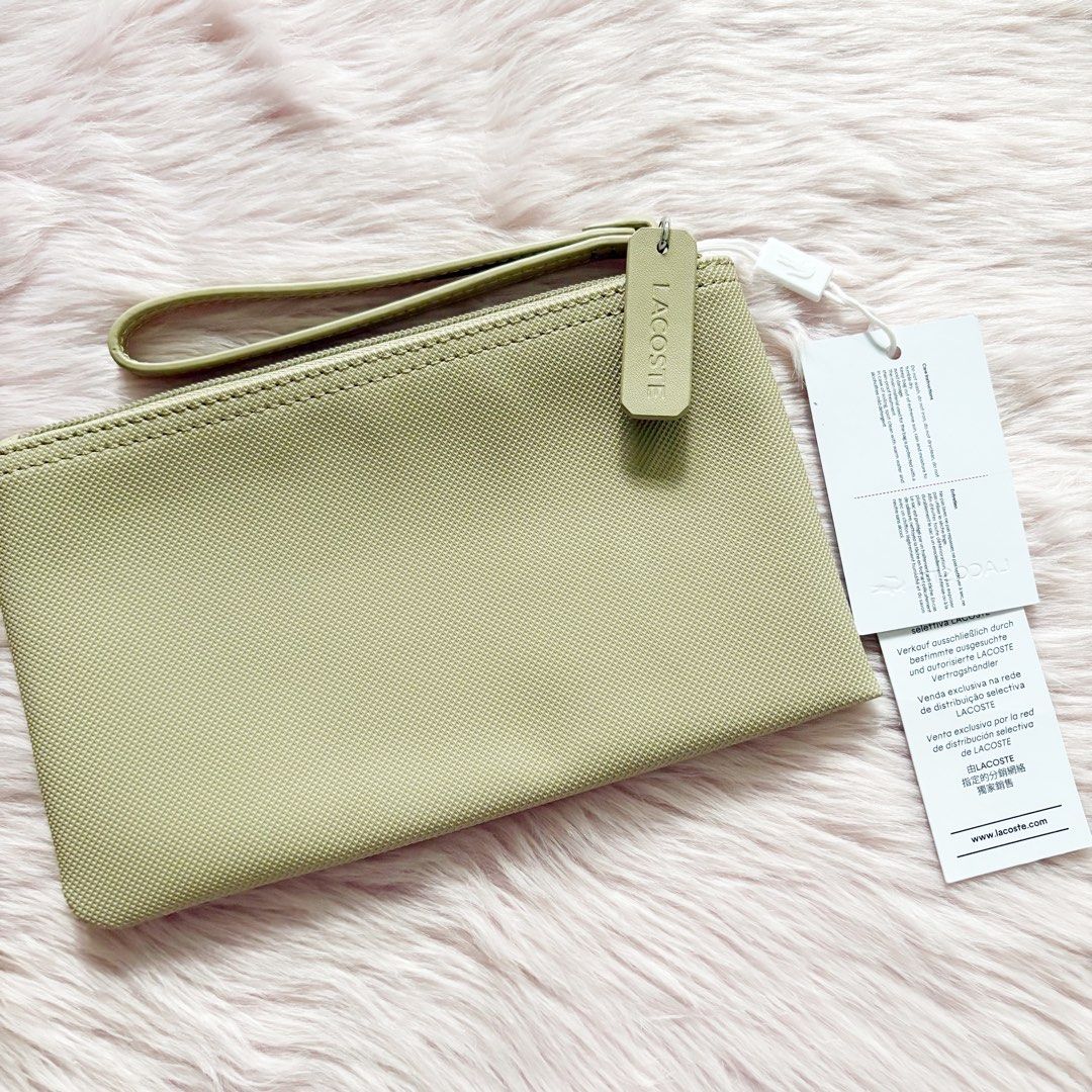 Lacoste Clutch in Beige/Brindille (Category: Purses & Pouches) located in Caloocan City. Submitted by _yownice (Listing ID 1428573830, Image 3). Description: Lacoste Clutch in Beige/Brindille 100% original, on hand ph and ready to ship Feature: - Lacoste branded zipper slider - Embroidered green Crocodile branding - Exterior in PVC Specifications: - Dimensions 8.2 x 4.7 x .4 in - Outside: Pvc (100%).