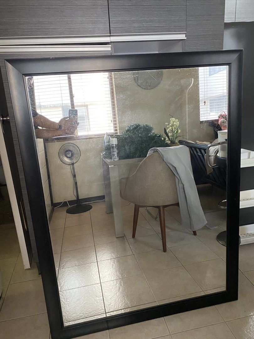 Large Black Framed Mirror (Category: Mirrors) located in Makati City. Submitted by rye16 (Listing ID 1428605048, Image 1). Description: Large rectangular mirror with a black frame. The mirror is suitable for a living room or bedroom. It has a simple, modern design. The mirror is clean and reflects the surrounding environment..