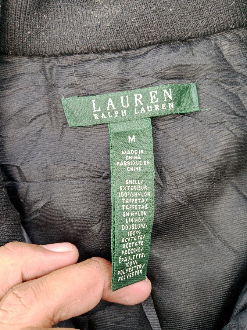 Lauren Ralph Lauren Quilted Jacket - Black - Medium (Category: Coats, Jackets and Outerwear) located in Tanza. Submitted by llcoolj. (Listing ID 1428443903, Image 2). Description: Black quilted jacket from Lauren Ralph Lauren. Features a zip closure, multiple pockets, and gold-tone buttons. The jacket is size M and made in China. The shell is 100% nylon, with a polyester lining and padding. The jacket has a classic design, suitable for various oc