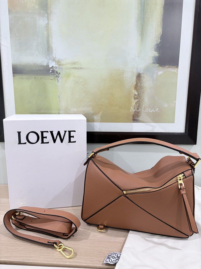 Loewe medium puzzle bag in tan complete inclusions (Category: Luxury Bags & Wallets) located in Quezon City. Submitted by herluxe_official (Listing ID 1428445961, Image 3). Description: Loewe Medium Puzzle Bag Bought from Hongkong. Dimensions: Medium: (28/29 x 19 x 14 cm) ✈️WE SHIP NATIONWIDE ✅SAME DAY DISPATCH Complete inclusions Dustbag, paperbag, cards and box .