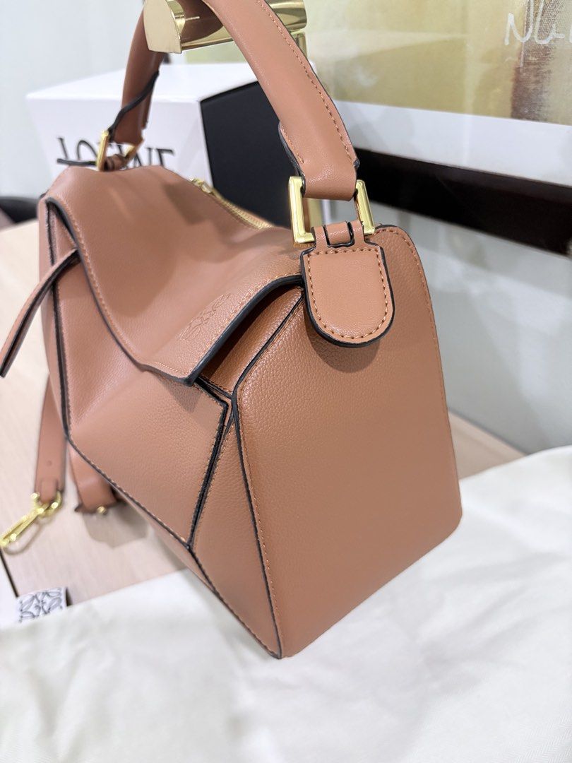 Loewe medium puzzle bag in tan complete inclusions (Category: Luxury Bags & Wallets) located in Quezon City. Submitted by herluxe_official (Listing ID 1428445961, Image 2). Description: Loewe Medium Puzzle Bag Bought from Hongkong. Dimensions: Medium: (28/29 x 19 x 14 cm) ✈️WE SHIP NATIONWIDE ✅SAME DAY DISPATCH Complete inclusions Dustbag, paperbag, cards and box .