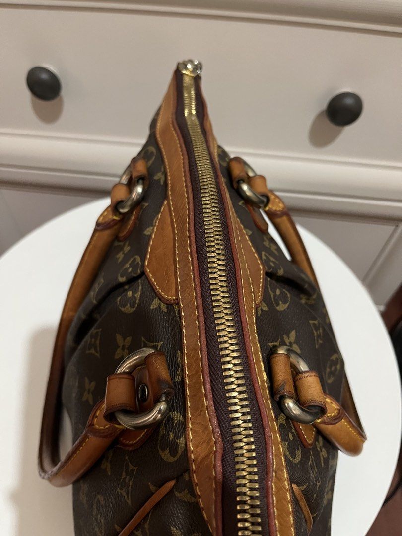 Louis Vuitton Monogram Canvas Bag (Category: Luxury Bags & Wallets) located in Manila. Submitted by sungjaneshop15 (Listing ID 1428436850, Image 3). Description: Louis Vuitton handbag in classic Monogram.Features a zip closure, leather handles, and a spacious interior with a pocket. The bag has a brown canvas exterior with the iconic LV pattern. The base has protective metal studs. Interior includes a small pocket and a leather tag with the seria