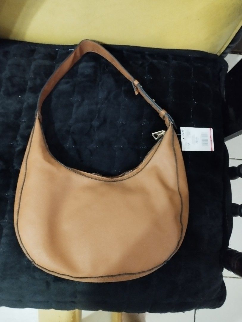 Mango Shoulder Bag Bundle sale with long Kipling wallet (Category: Shoulder Bags) located in Caloocan City. Submitted by myprelovedbutlovedshop (Listing ID 1428503980, Image 3). Description: Mango shoulder bag in a warm brown color. Features a single shoulder strap and a zip closure. The interior is black. The bag has a Mango logo on the front. Includes a tag. If you buy this bag, you'll get a free red Kipling long wallet. Pls note that the freeb