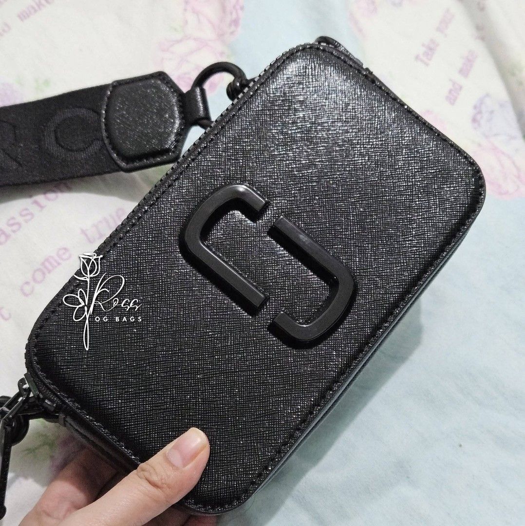 Marc Jacobs The Box Bag Black (Category: Luxury Bags & Wallets) located in Quezon City. Submitted by handpickerbag (Listing ID 1428428318, Image 1). Description: Black Marc Jacobs The Box Bag. Features a rectangular shape with a double-zip closure. Includes a detachable and adjustable shoulder strap. The bag has a textured finish and the iconic 'J' logo in black..