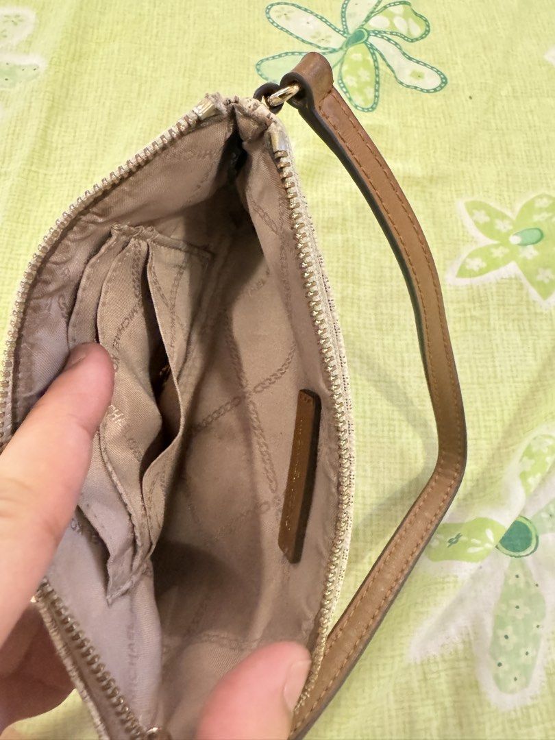 Michael Kors Wristlet (Category: Luxury Bags & Wallets) located in Tarlac. Submitted by TanGi_rine (Listing ID 1428468141, Image 3). Description: RFS: nakatambak lang.. See flaws sa last 2 photos.. Plus shipping fee...