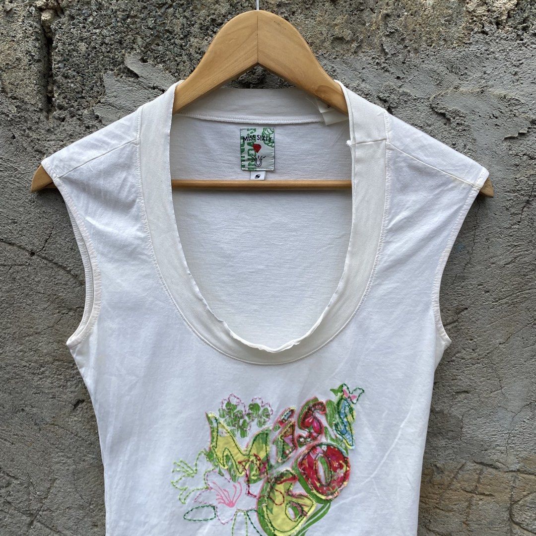Miss Sixty Sleeveless Top (Category: Sleeveless) located in Manila. Submitted by d____g (Listing ID 1428545545, Image 3). Description: White sleeveless top from Miss Sixty. Features a scoop neckline and a colorful embroidered design on the front. The tag indicates a size S. Made in Italy. The top has a unique design with a mix of floral and abstract elements..