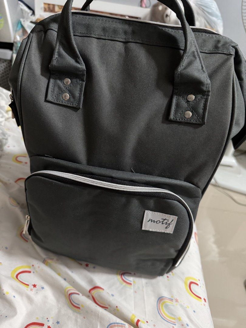 Motif Diaper Bag with 4 Bottles (Category: Diaper Bags & Wetbags) located in Makati City. Submitted by marowebg (Listing ID 1428540740, Image 1). Description: Motif diaper bag is perfect for parents on the go. It features multiple compartments, including insulated pockets and a spacious interior. The bag comes with several Motif baby bottles. It has a stylish design with a front pocket and comfortable backpack straps..
