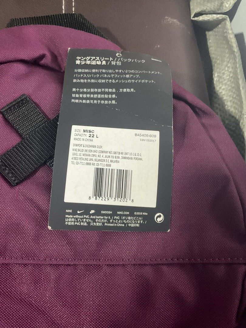 Nike Elemental Backpack (Category: Backpacks) located in Manila. Submitted by epiccloud.3db379 (Listing ID 1428499189, Image 2). Description: Nike Elemental backpack features a vibrant purple color with a large pink Nike swoosh. It has multiple compartments, including a side pocket and a front zippered pocket. The bag has a capacity of 21L. It is designed for young athletes and includes a tag with product details..