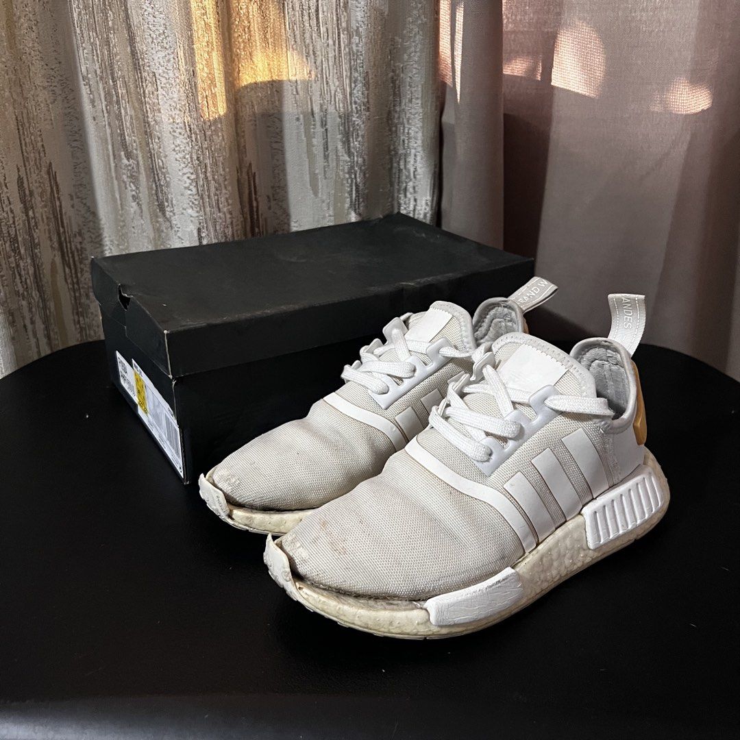 Original ADIDAS NMD_R1 - White Sneakers (Category: Sneakers) located in Manila. Submitted by adc007 (Listing ID 1428515709, Image 1). Description: 💯Original ✅ Pre-loved ✅ Usable condition (Has minor flaws) ✅ W/ Box Brand: ADIDAS Color: White w/ Black and Gold accents Size: US Men: 4.5 US Women: 5.5 RFS: No longer using this. Still usable but has minor defects. Message me for more pictures or for further inquiries! MOP: Gcash, Bank transfer, COD 