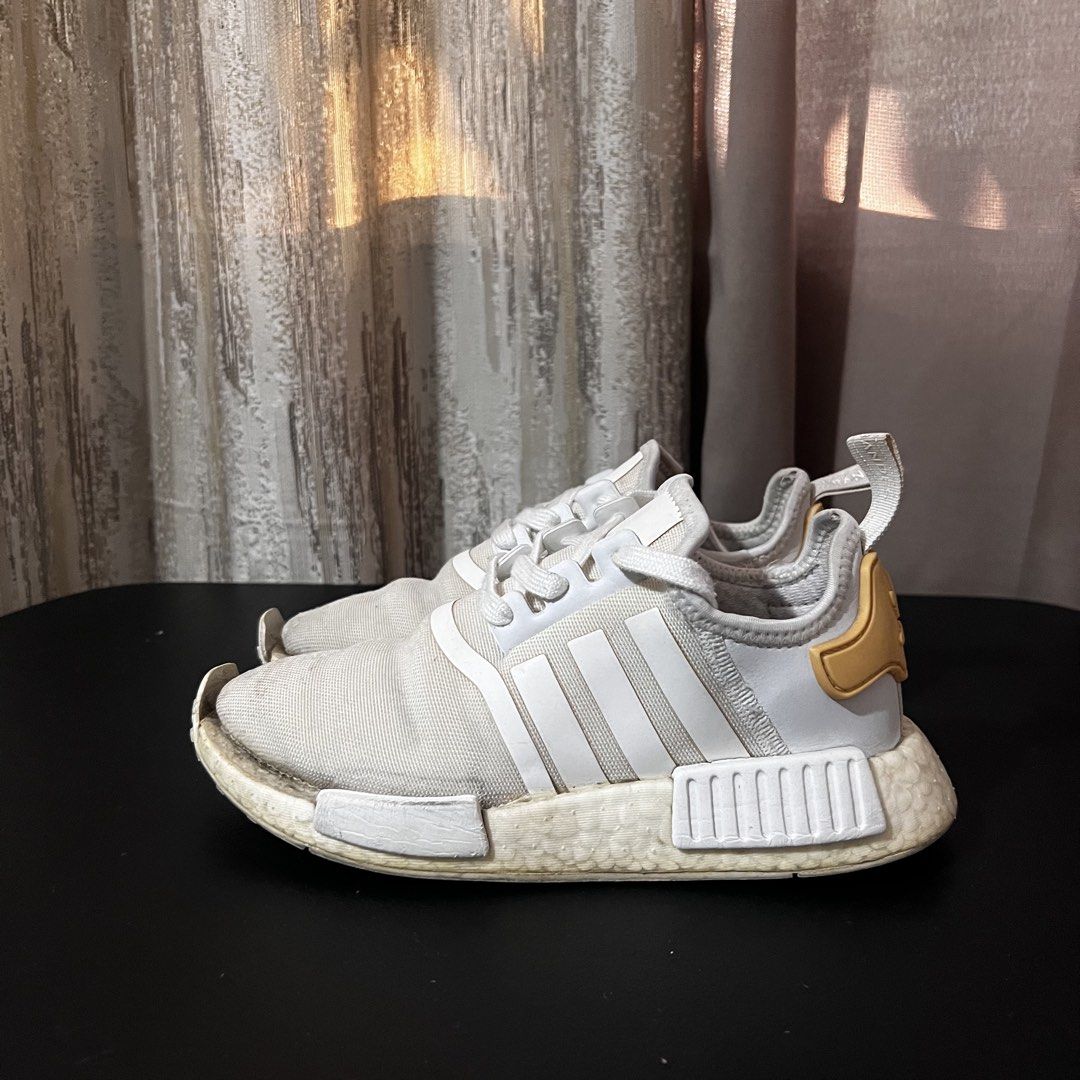 Original ADIDAS NMD_R1 - White Sneakers (Category: Sneakers) located in Manila. Submitted by adc007 (Listing ID 1428515709, Image 2). Description: 💯Original ✅ Pre-loved ✅ Usable condition (Has minor flaws) ✅ W/ Box Brand: ADIDAS Color: White w/ Black and Gold accents Size: US Men: 4.5 US Women: 5.5 RFS: No longer using this. Still usable but has minor defects. Message me for more pictures or for further inquiries! MOP: Gcash, Bank transfer, COD 