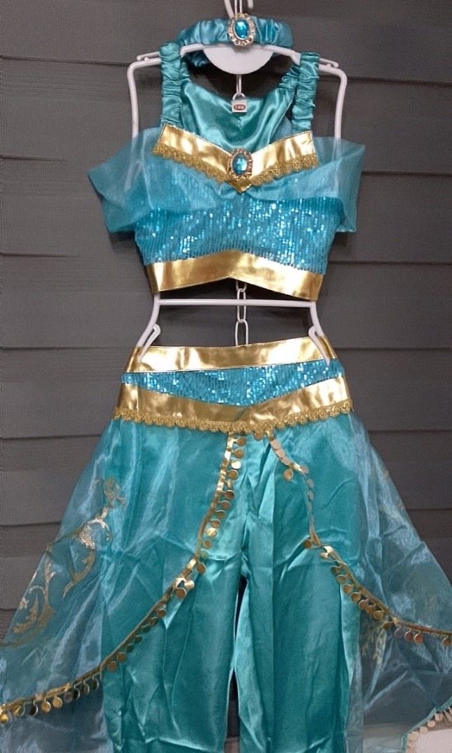Princess Jasmine Costume (Category: Babies & Kids Fashion) located in Pasig City. Submitted by sweetchinchin15 (Listing ID 1428601205, Image 1). Description: Beautiful Princess Jasmine costume for girls. It includes a top, pants, and a headpiece. The costume is in a vibrant blue color with gold accents. It is perfect for dress-up, parties, or Halloween. The costume is designed to resemble the outfit worn by Princess Jasmine in the Aladdin movie. 